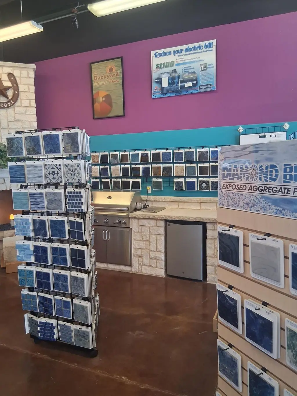 Showroom inside the store with tile sample towers, an outdoor kitchen display and a Diamond Brite finish board